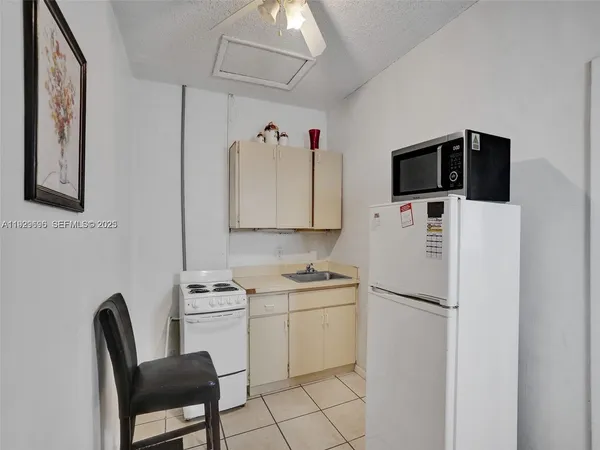 a kitchen with a sink cabinets and appliances