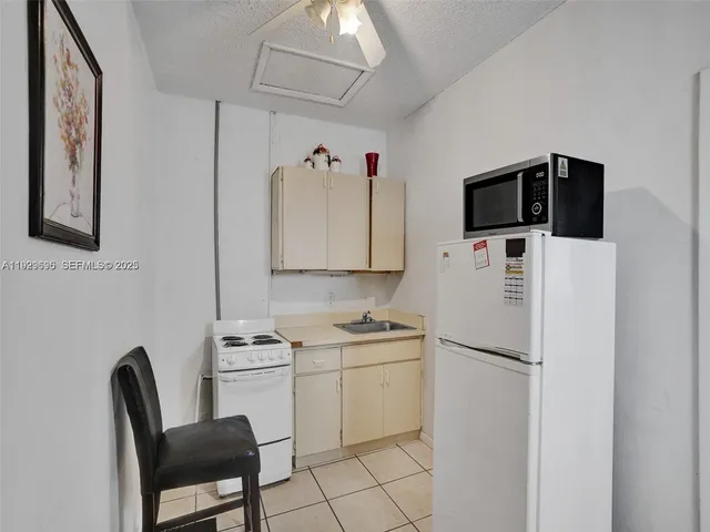 a kitchen with a sink cabinets and appliances
