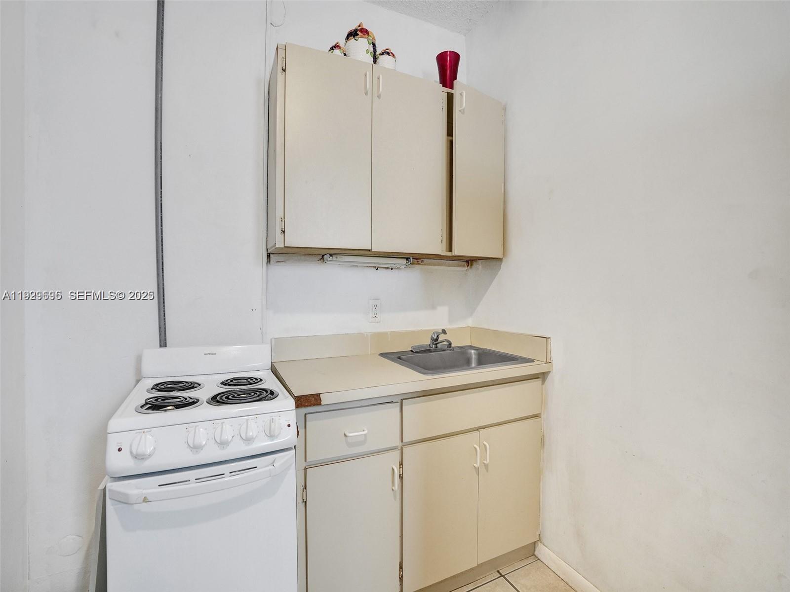 15455 North Miami Avenue, Unit A Miami, FL 33169 - Photo 6 of 10 a kitchen with a sink cabinets and white appliances
