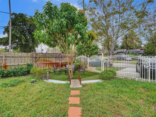 a view of a house with a yard and a garden