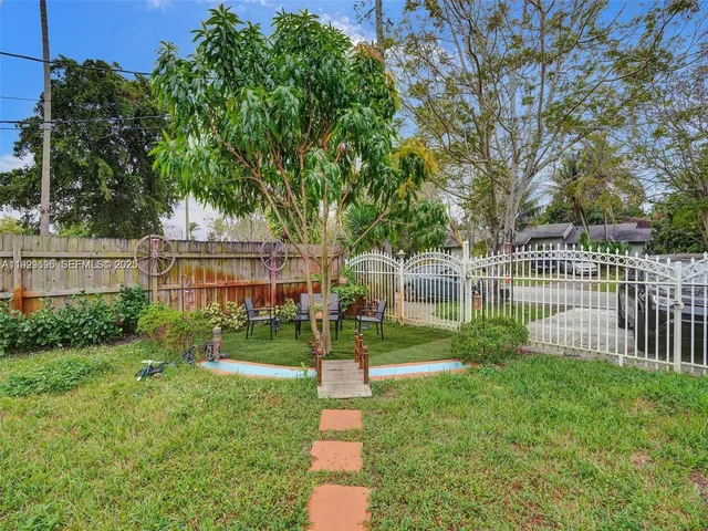a view of a house with a yard and a garden