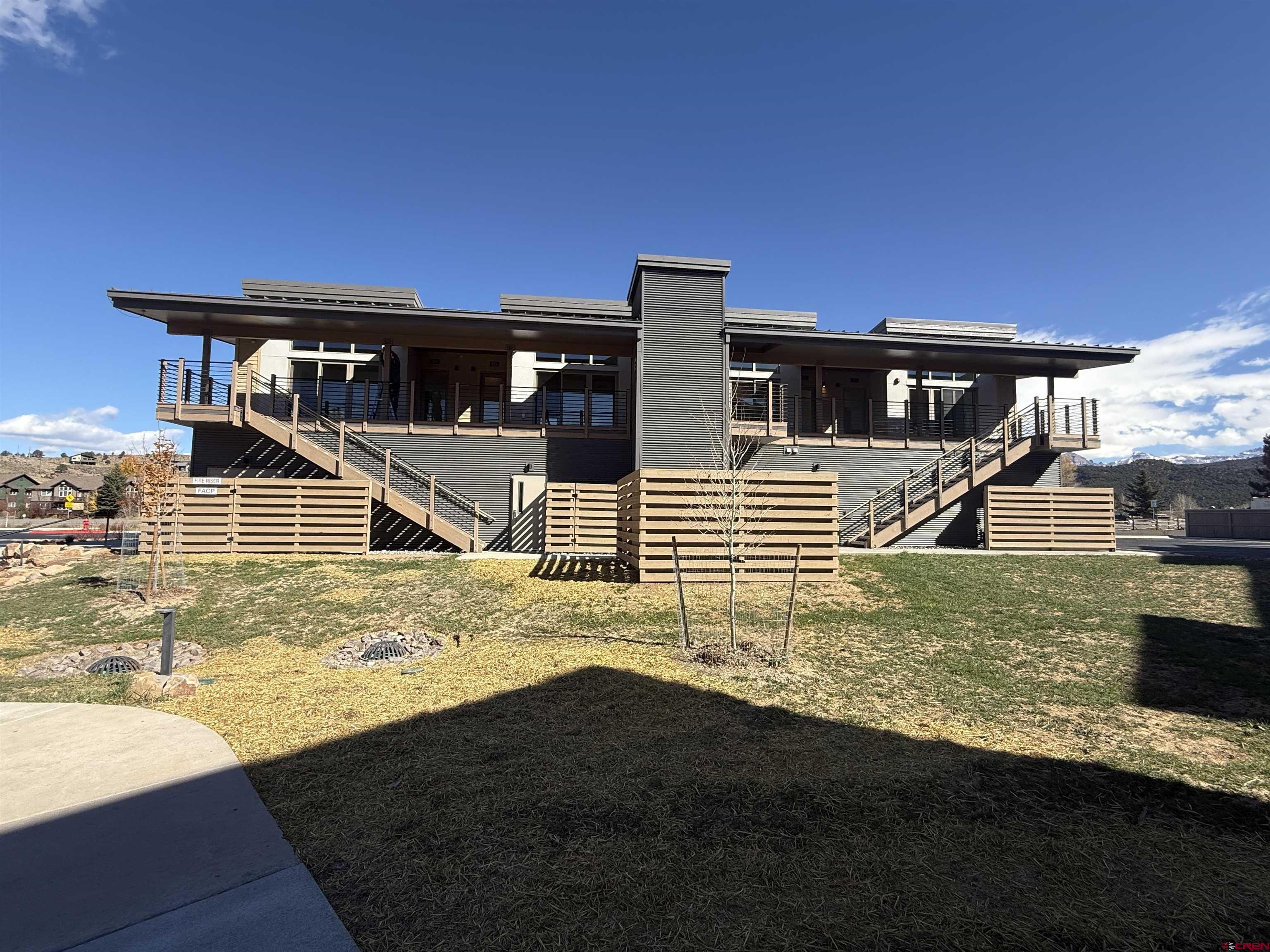 205 Jasper Lane, Unit 102 Ridgway, CO 81432 - Photo 23 of 29 a front view of a house with a yard