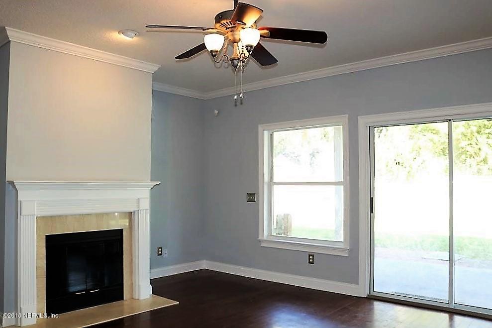 1821 Dunsford Road Jacksonville, FL 32207 - Photo 8 of 25 a living room with a fireplace and a window