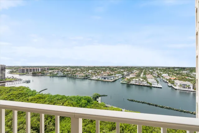 a view of a lake with a city from a balcony