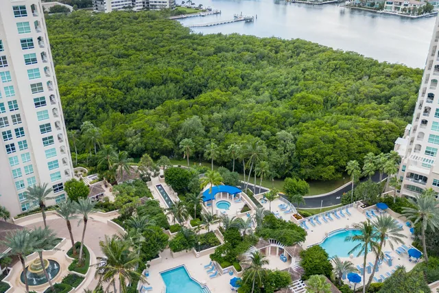 an aerial view of a house with a yard and lake view