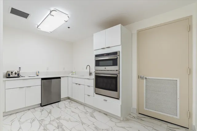 a view of a dining room with furniture a livingroom and kitchen view
