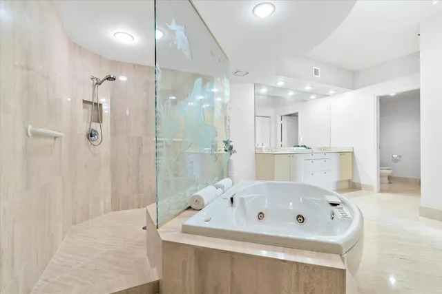 a bathroom with a tub a sink and a shower