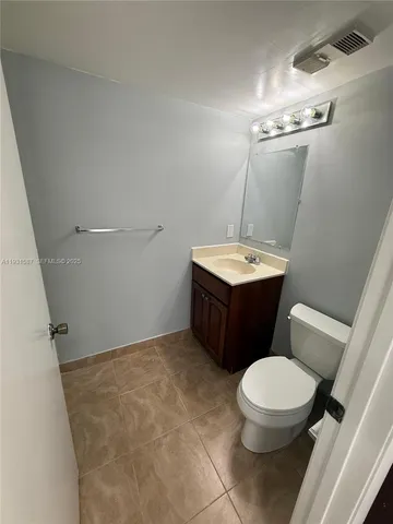 a bathroom with a sink a toilet a mirror and vanity