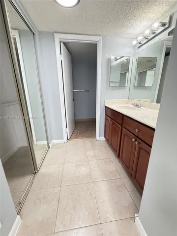 a bathroom with a sink a mirror and a vanity