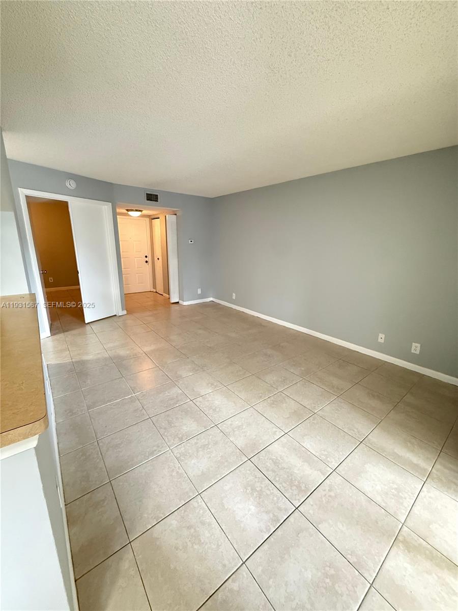 9855 Westview Drive, Unit 711 Coral Springs, FL 33076 - Photo 3 of 12 a view of an empty room and a window