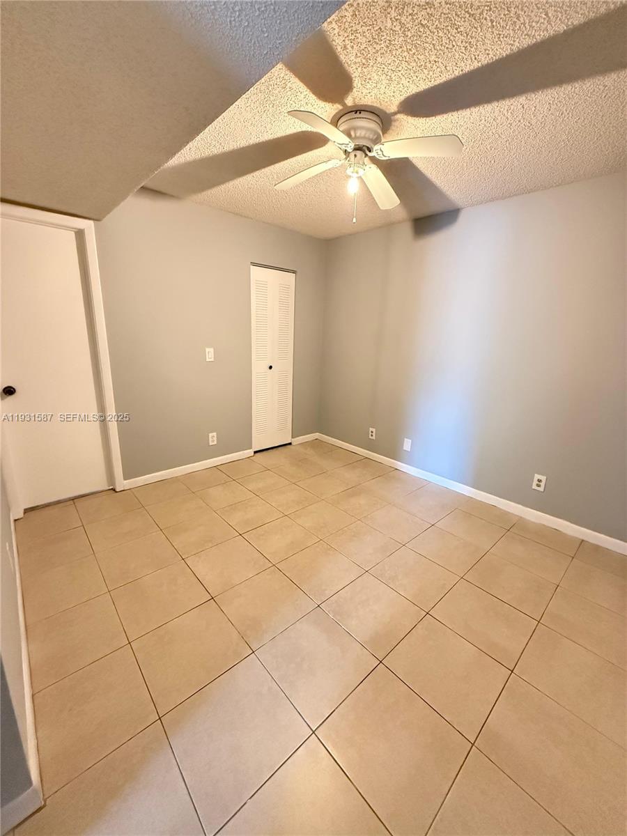 9855 Westview Drive, Unit 711 Coral Springs, FL 33076 - Photo 4 of 12 a view of a room with a ceiling fan and window
