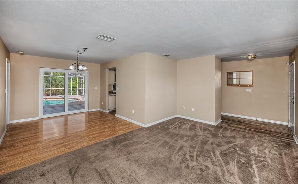 443 Fairmont Terrace Port Charlotte, FL 33954 - Photo 17 of 77 a view of an empty room with wooden floor and a window