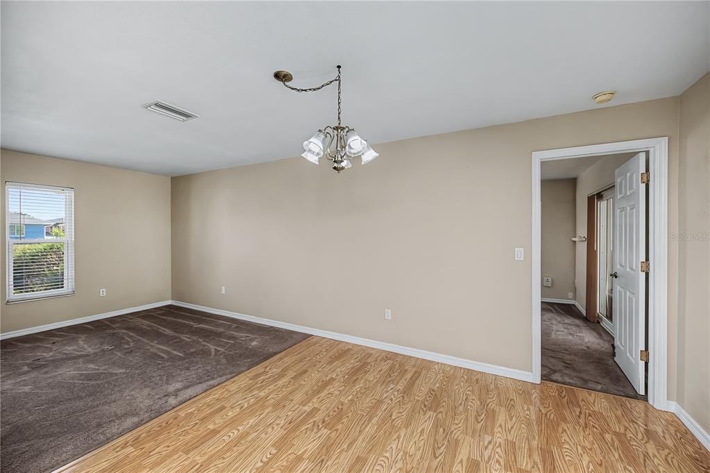 443 Fairmont Terrace Port Charlotte, FL 33954 - Photo 20 of 77 a view of a room with wooden floor and chandelier