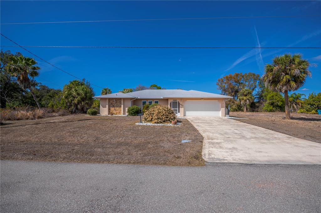 443 Fairmont Terrace Port Charlotte, FL 33954 - Photo 2 of 77 a front view of a house with a yard and a garage