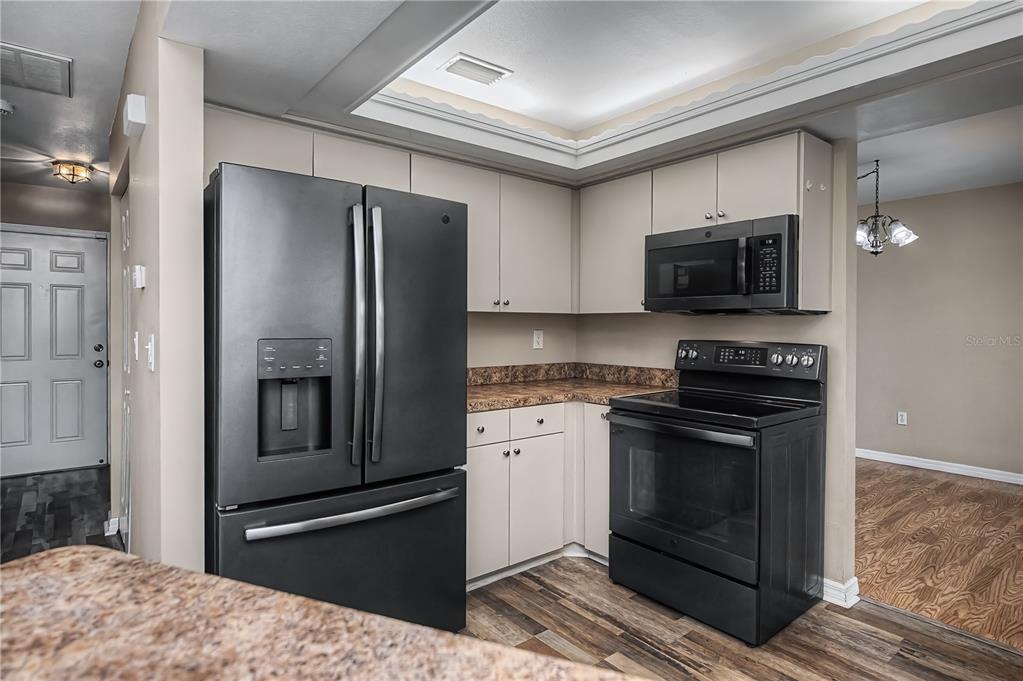 443 Fairmont Terrace Port Charlotte, FL 33954 - Photo 25 of 77 a kitchen with granite countertop a refrigerator and a stove top oven