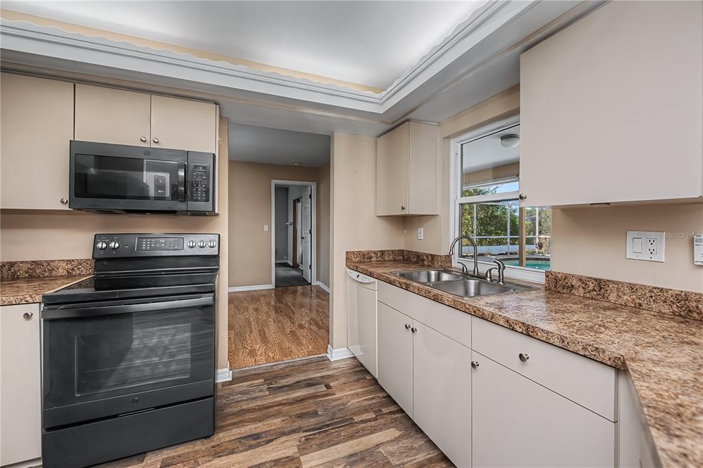 443 Fairmont Terrace Port Charlotte, FL 33954 - Photo 27 of 77 a kitchen with stainless steel appliances granite countertop a stove microwave and sink
