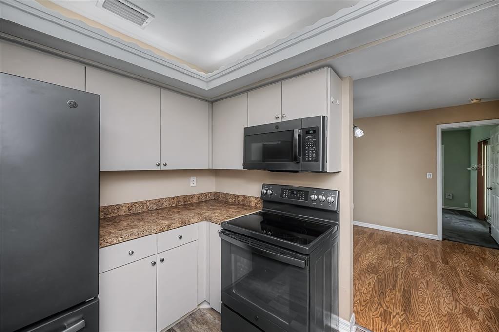 443 Fairmont Terrace Port Charlotte, FL 33954 - Photo 29 of 77 a kitchen with granite countertop a sink stove and microwave
