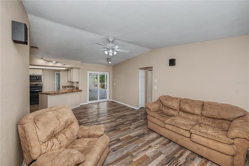443 Fairmont Terrace Port Charlotte, FL 33954 - Photo 34 of 77 a living room with furniture and a chandelier