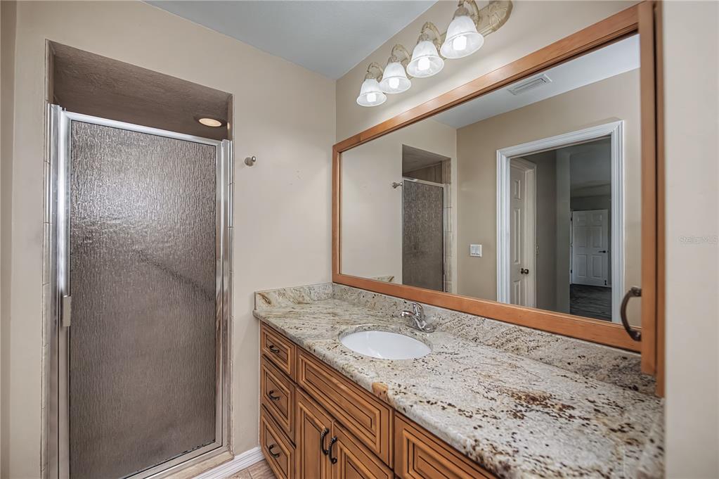 443 Fairmont Terrace Port Charlotte, FL 33954 - Photo 42 of 77 a bathroom with a granite countertop sink and a mirror