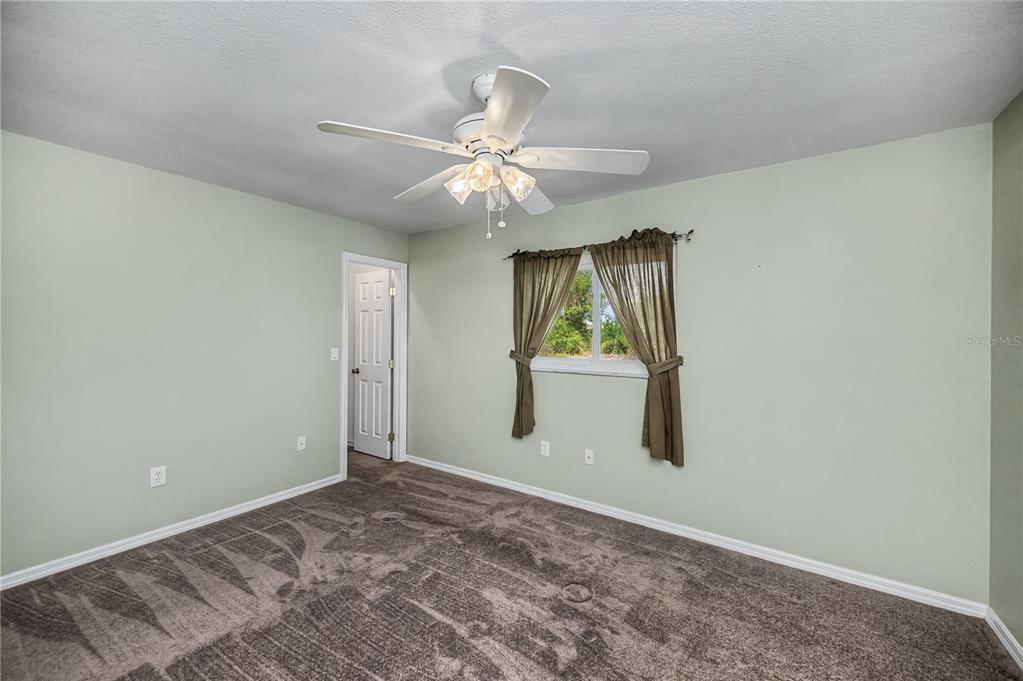 443 Fairmont Terrace Port Charlotte, FL 33954 - Photo 45 of 77 an empty room with windows and fan