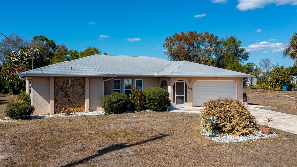 443 Fairmont Terrace Port Charlotte, FL 33954 - Photo 5 of 77 a front view of a house with a yard