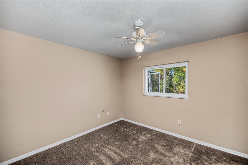 443 Fairmont Terrace Port Charlotte, FL 33954 - Photo 51 of 77 an empty room with a window and ceiling fan