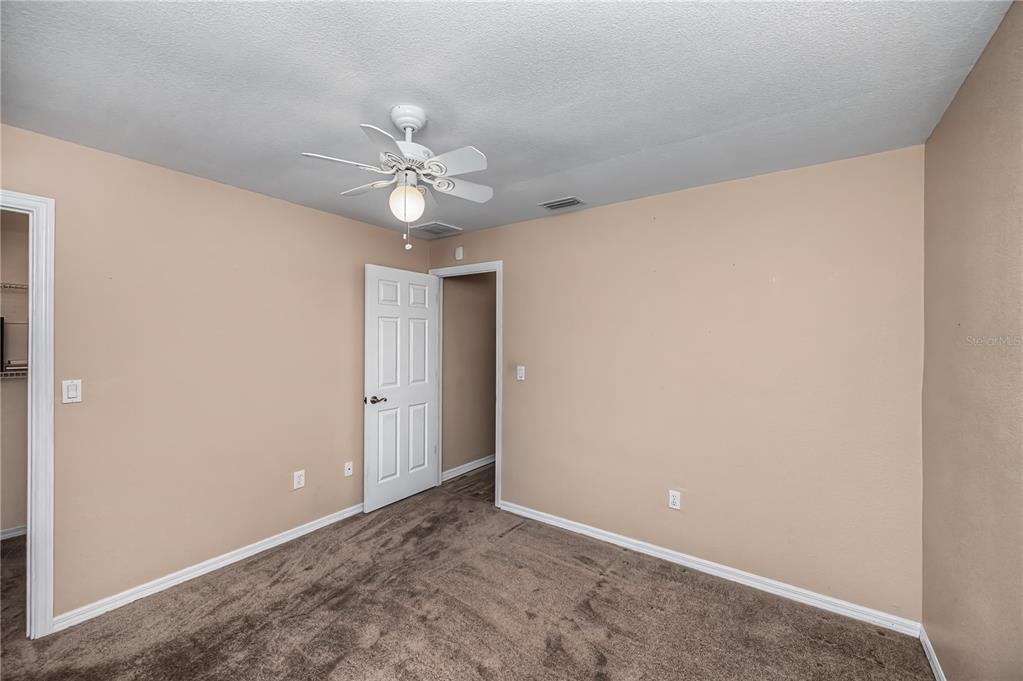 443 Fairmont Terrace Port Charlotte, FL 33954 - Photo 53 of 77 an empty room with a ceiling fan and a window