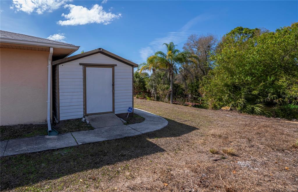 443 Fairmont Terrace Port Charlotte, FL 33954 - Photo 74 of 77 a front view of a house with a yard