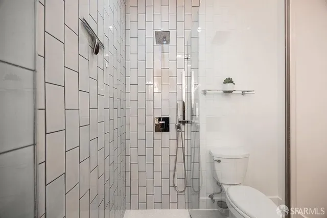 a bathroom with a toilet and shower
