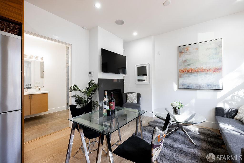 3418 26th Street, Unit 1 San Francisco, CA 94110 - Photo 6 of 20 a living room with furniture a flat screen tv and a fireplace