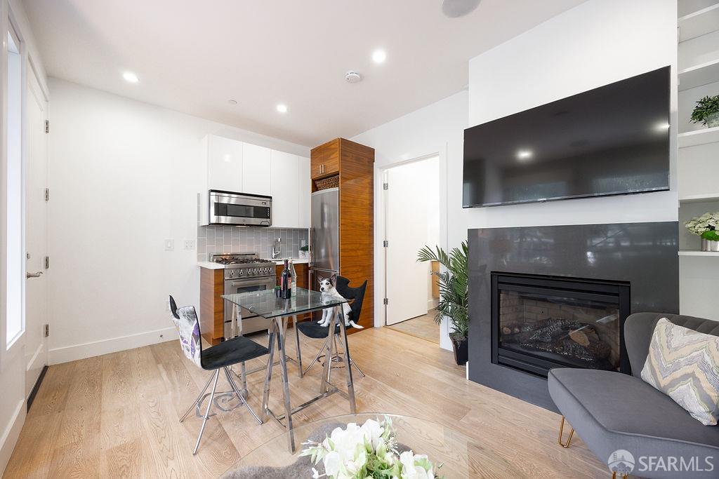 3418 26th Street, Unit 1 San Francisco, CA 94110 - Photo 7 of 20 a living room with furniture a flat screen tv and a fireplace