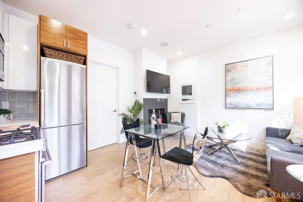 3418 26th Street, Unit 1 San Francisco, CA 94110 - Photo 8 of 20 a view of a dining room with furniture a kitchen and chandelier