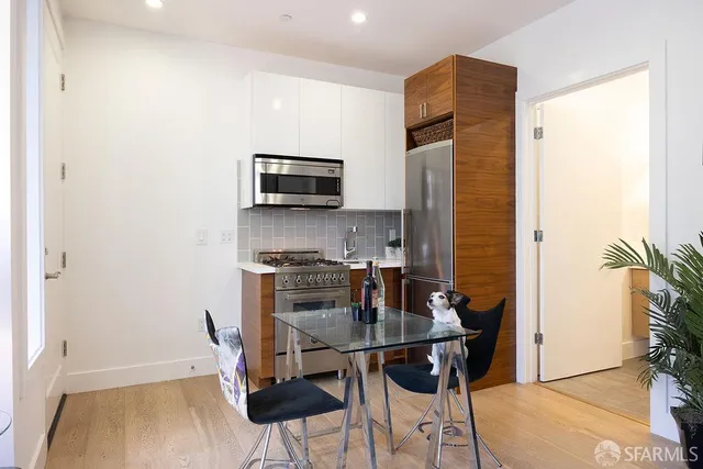 a kitchen with stainless steel appliances a refrigerator and a stove top oven