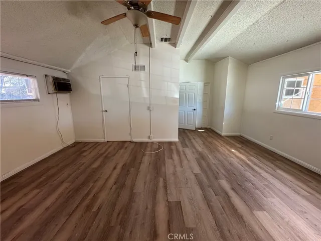 a view of a room with wooden floor