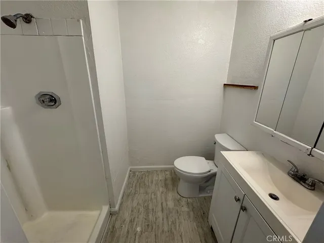 a white toilet sitting next to a bath tub