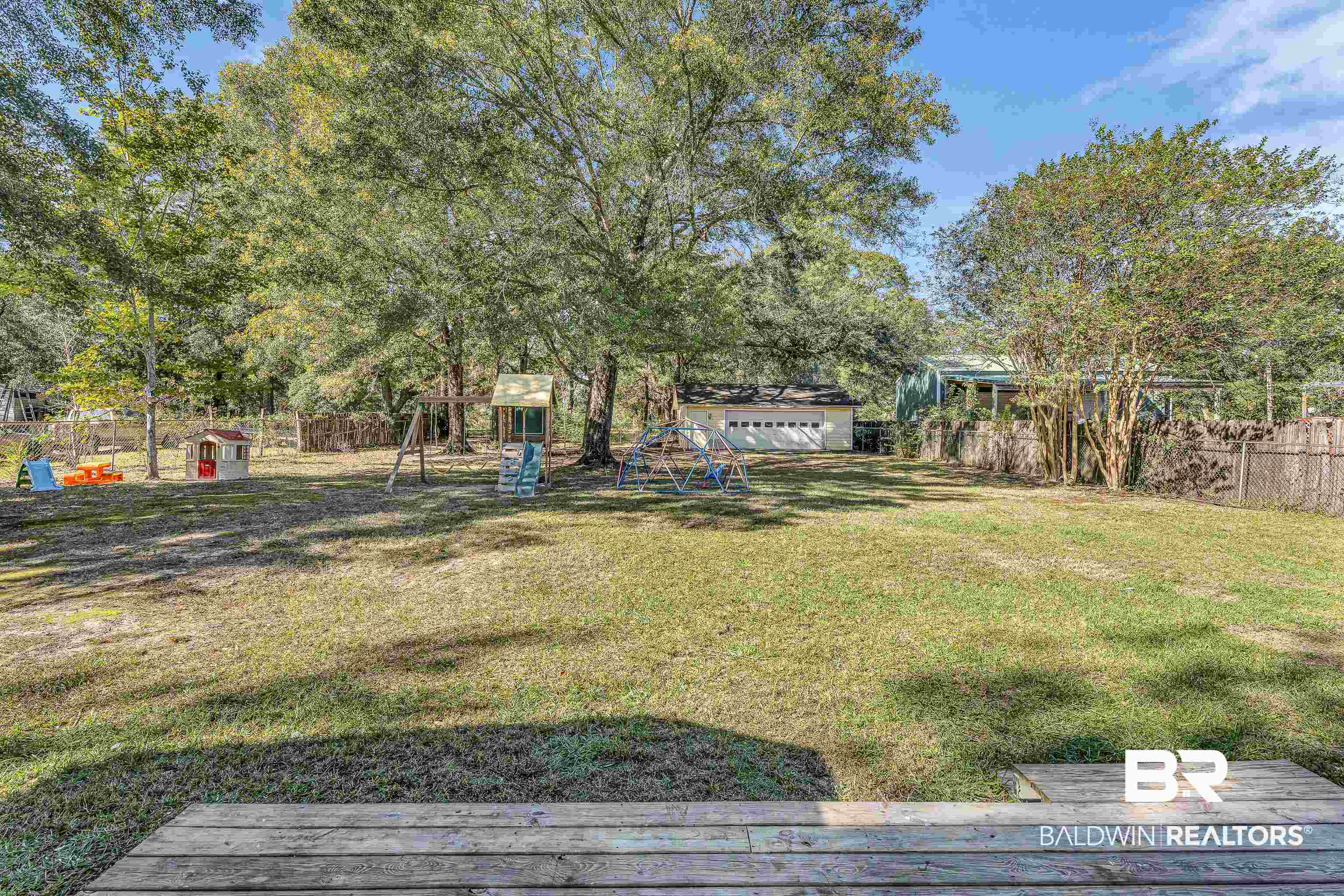 6135 Oak Cliff Drive Eight Mile, AL 36613 - Photo 27 of 30 Fenced backyard featuring view of wooded area and an outdoor structure