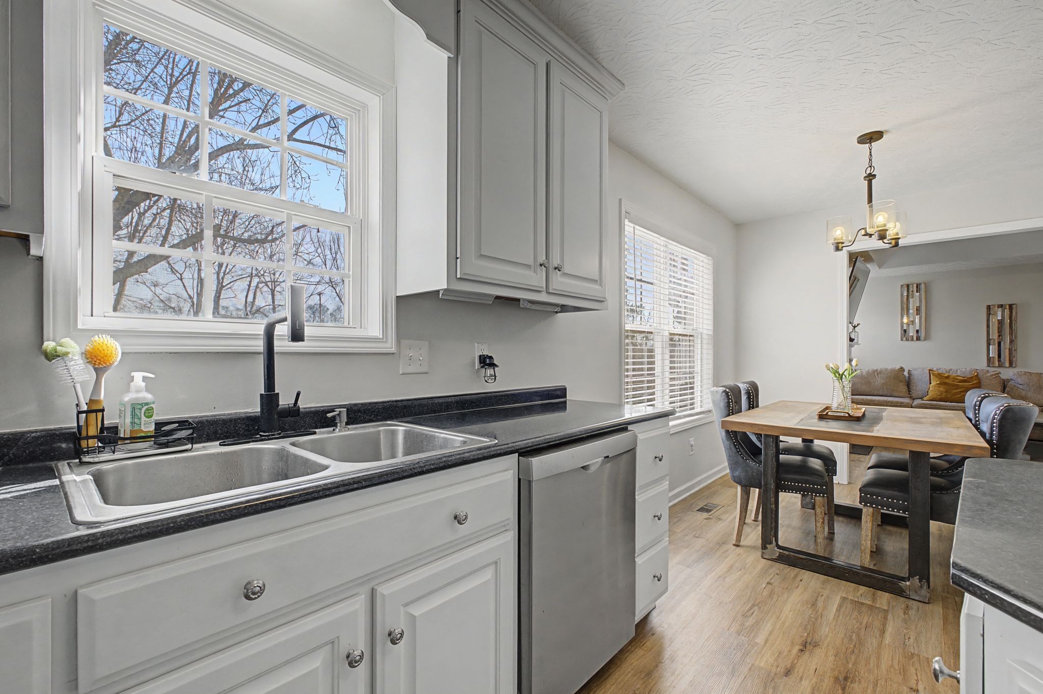 160 Putter Point Drive Gallatin, TN 37066 - Photo 15 of 35 a kitchen with stainless steel appliances granite countertop a sink dishwasher a stove and white cabinets with wooden floor