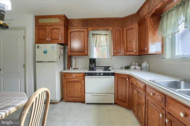 a kitchen with stainless steel appliances granite countertop a sink dishwasher stove top oven and refrigerator