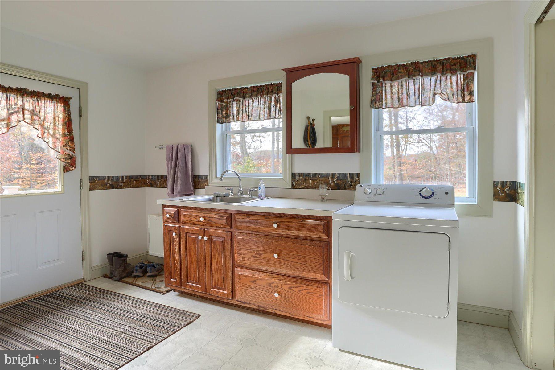 7504 Raccoon Valley Road Millerstown, PA 17062 - Photo 17 of 71 a bathroom with a granite countertop sink a mirror and a window