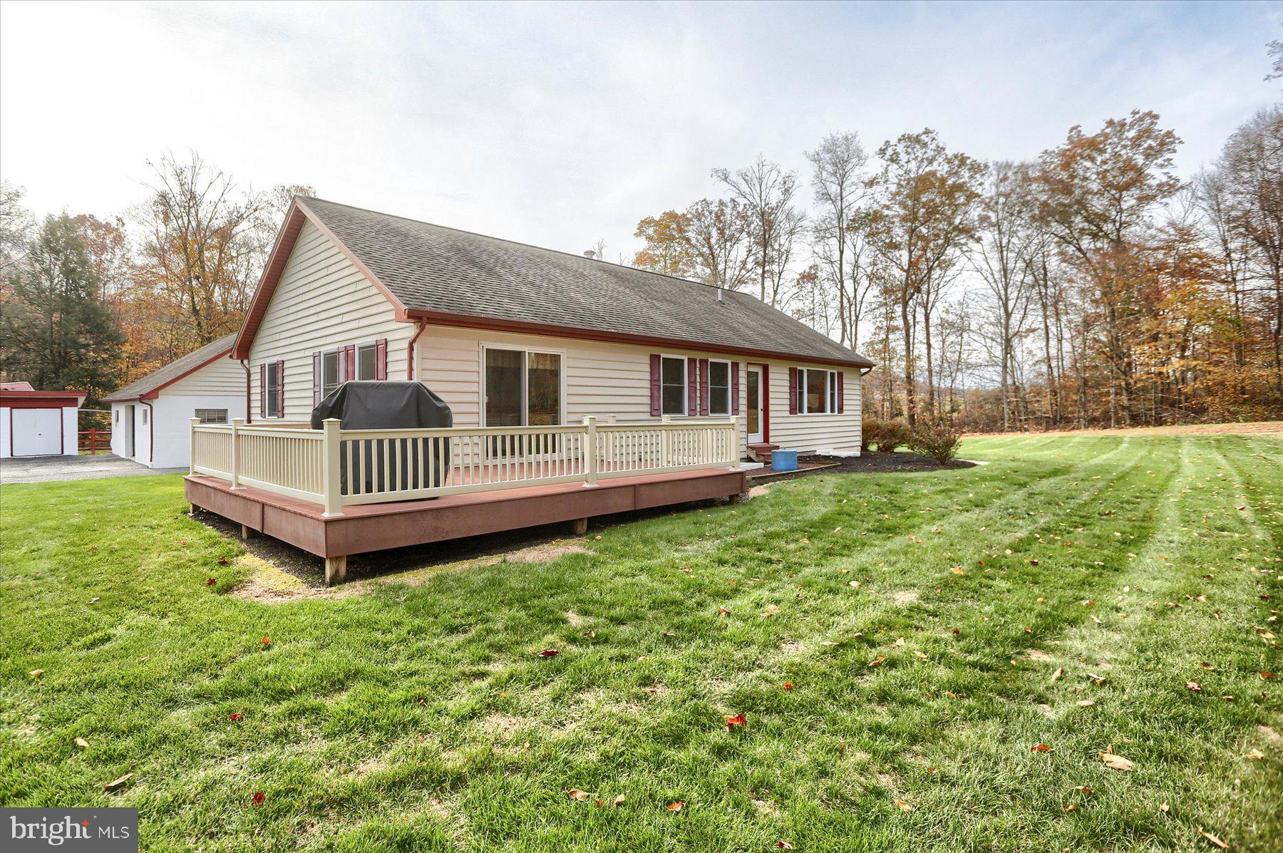 7504 Raccoon Valley Road Millerstown, PA 17062 - Photo 2 of 71 a view of a house with a yard and deck