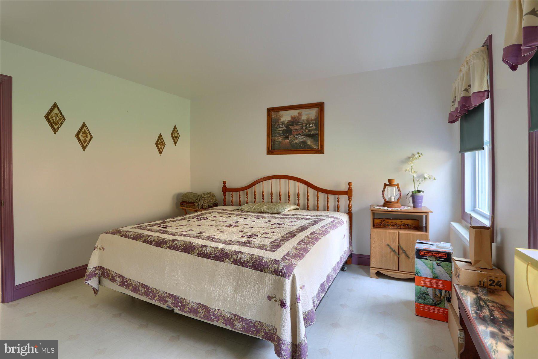 7504 Raccoon Valley Road Millerstown, PA 17062 - Photo 24 of 71 a bedroom with a bed and a table in it