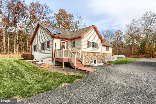 a view of a house with a yard and sitting area