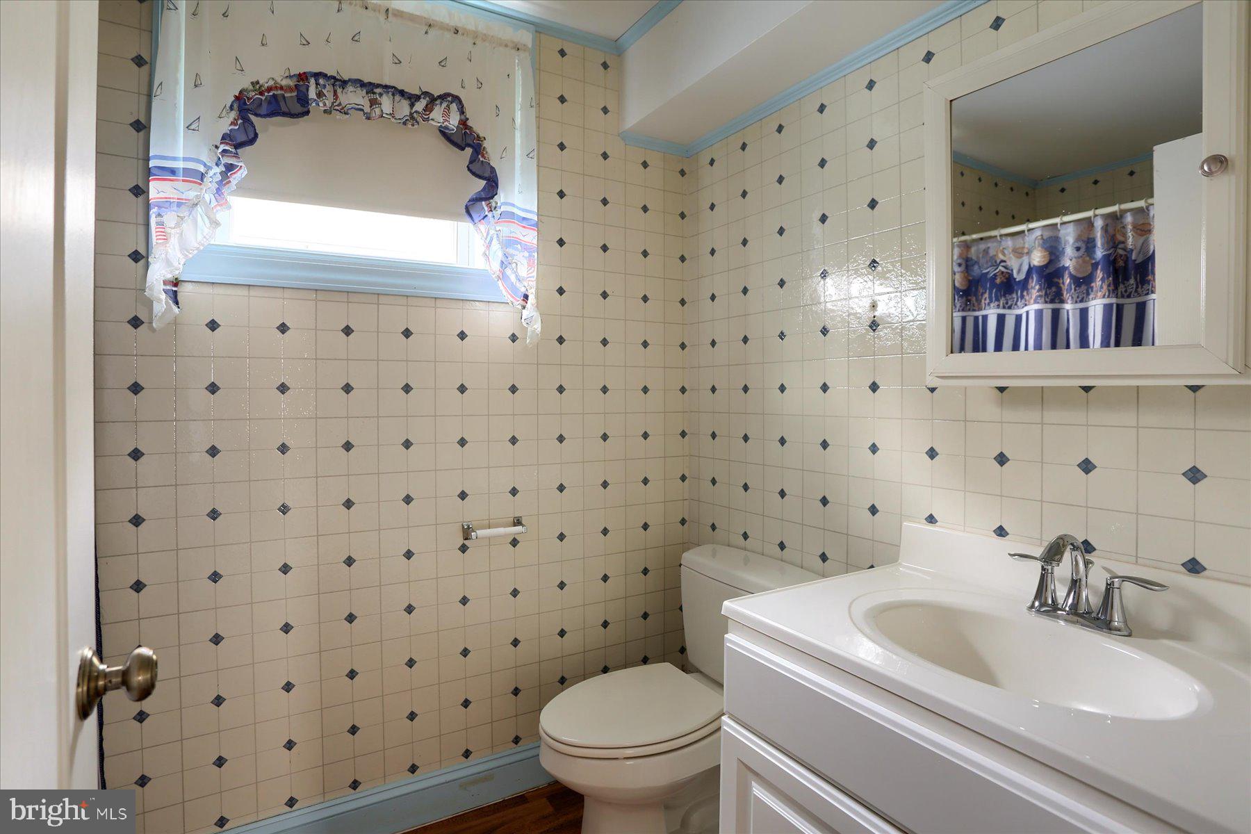 7504 Raccoon Valley Road Millerstown, PA 17062 - Photo 36 of 71 a bathroom with a sink toilet and mirror