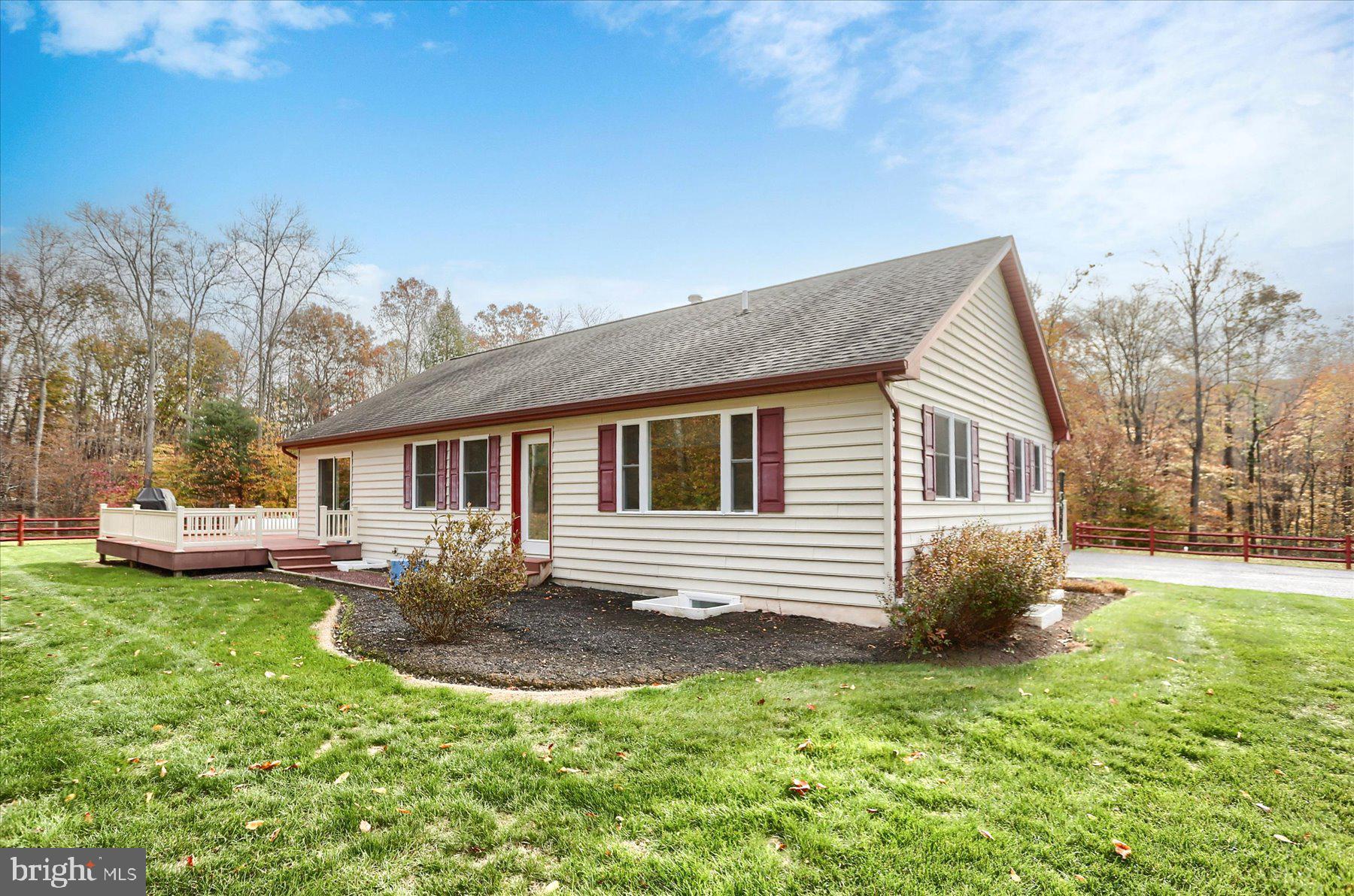 7504 Raccoon Valley Road Millerstown, PA 17062 - Photo 44 of 71 a front view of a house with a garden and trees