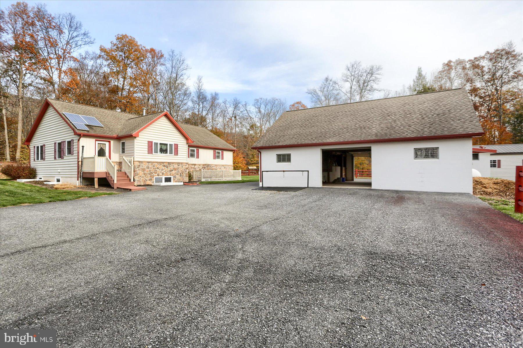 7504 Raccoon Valley Road Millerstown, PA 17062 - Photo 49 of 71 a view of a house with a yard and large trees