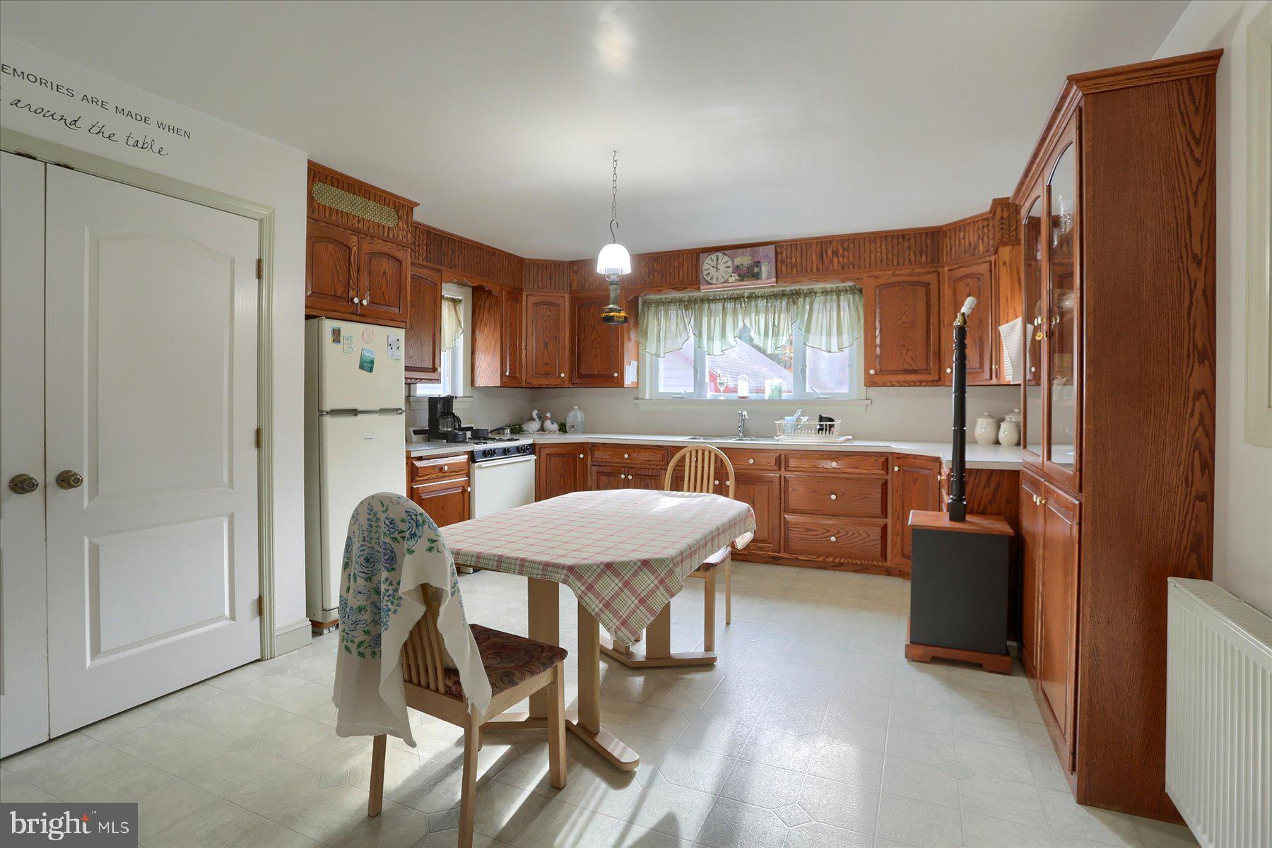 7504 Raccoon Valley Road Millerstown, PA 17062 - Photo 9 of 71 a kitchen with a table chairs refrigerator and cabinets