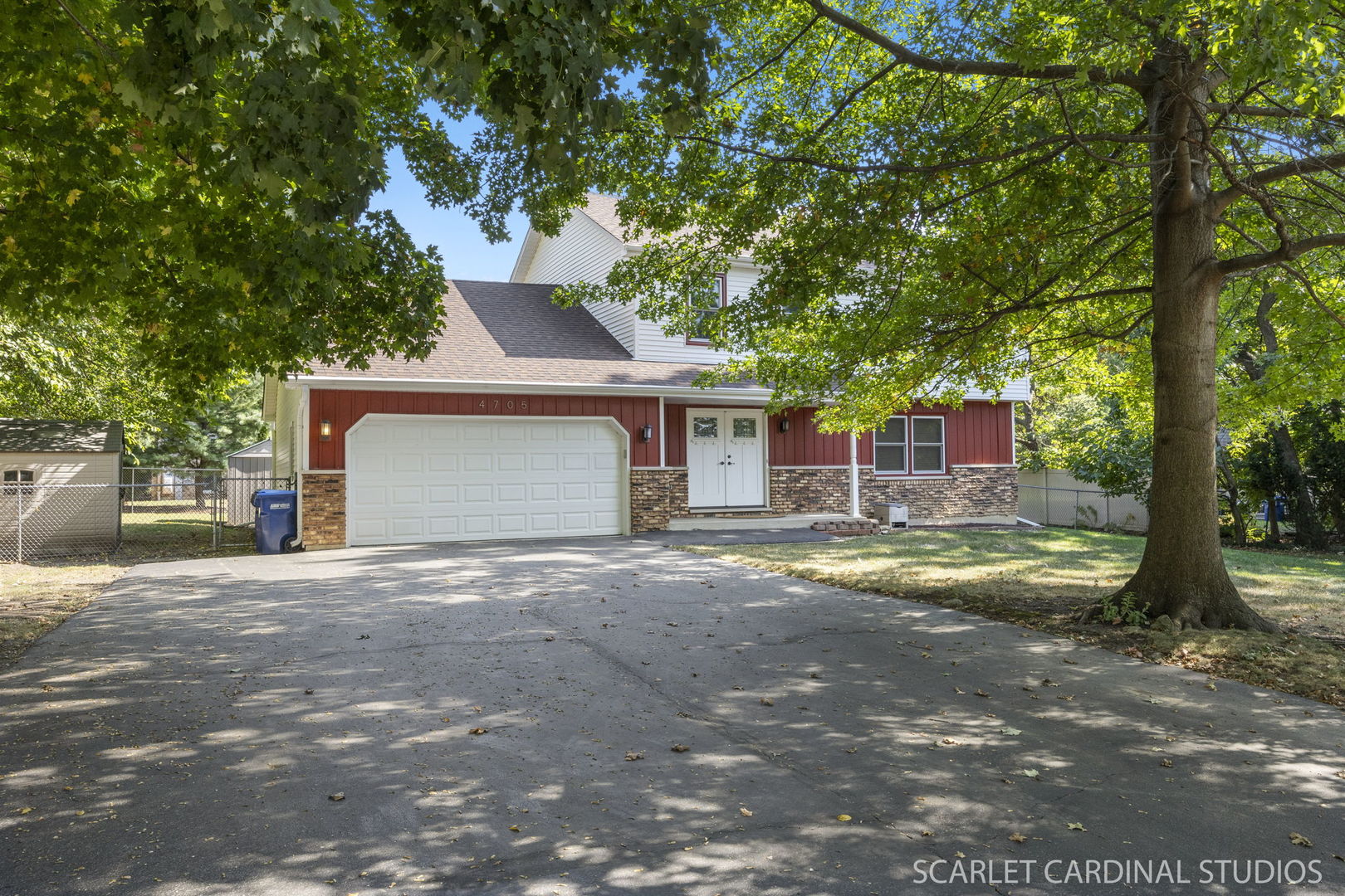 4705 Elm Street Lisle, IL 60532 - Photo 1 of 21 a front view of a house with a yard and garage