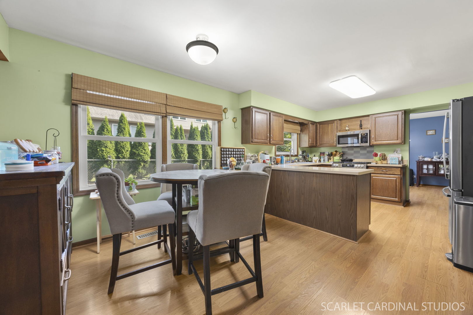 4705 Elm Street Lisle, IL 60532 - Photo 5 of 21 a kitchen with a table chairs refrigerator and cabinets