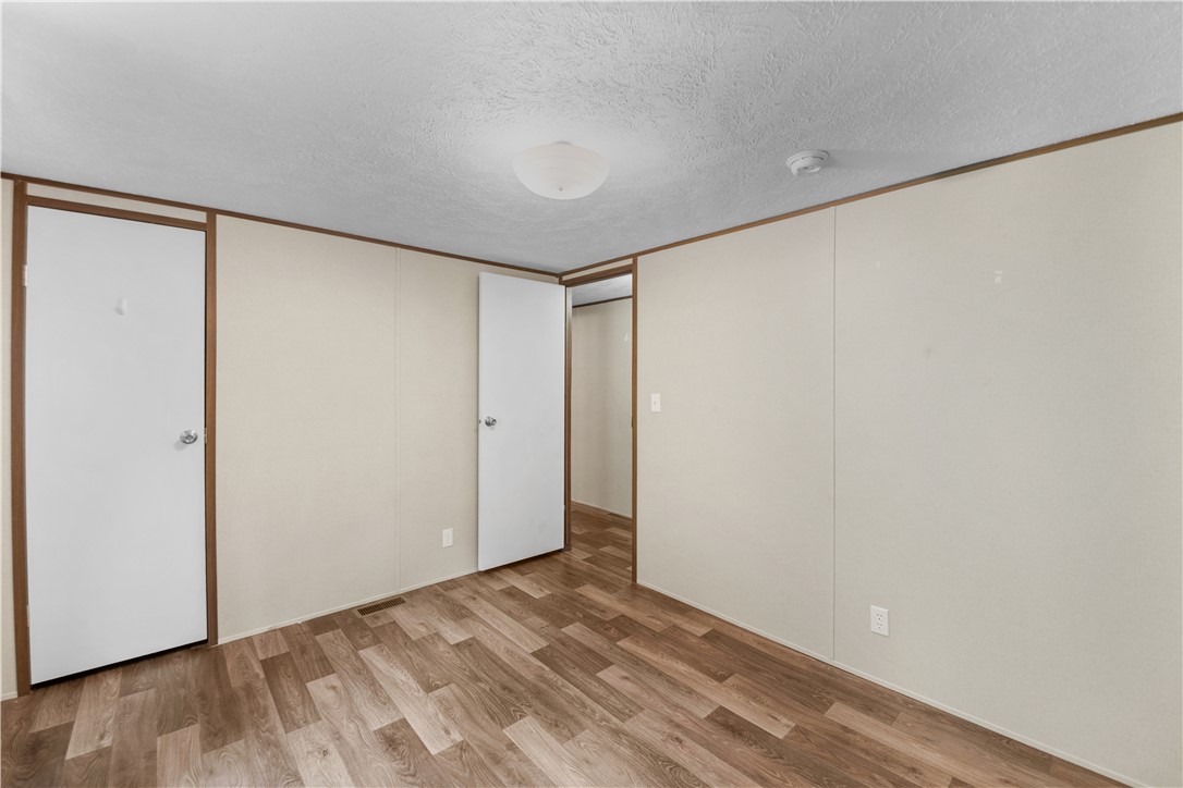 1188 Old Liberty Road Easley, SC 29640 - Photo 24 of 28 This spacious bedroom offers a tranquil retreat with warm flooring and ample closet space.