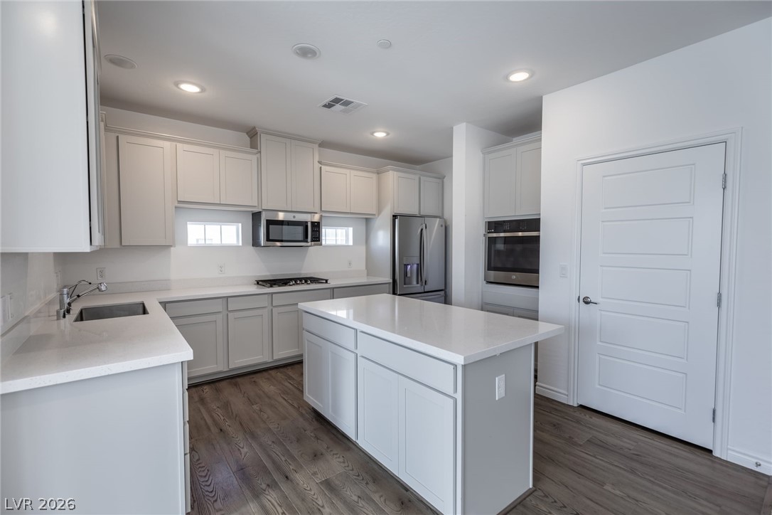 2555 Hampton Road, Unit 8206 Henderson, NV 89052 - Photo 10 of 35 This modern kitchen features a spacious island and sleek, contemporary appliances.